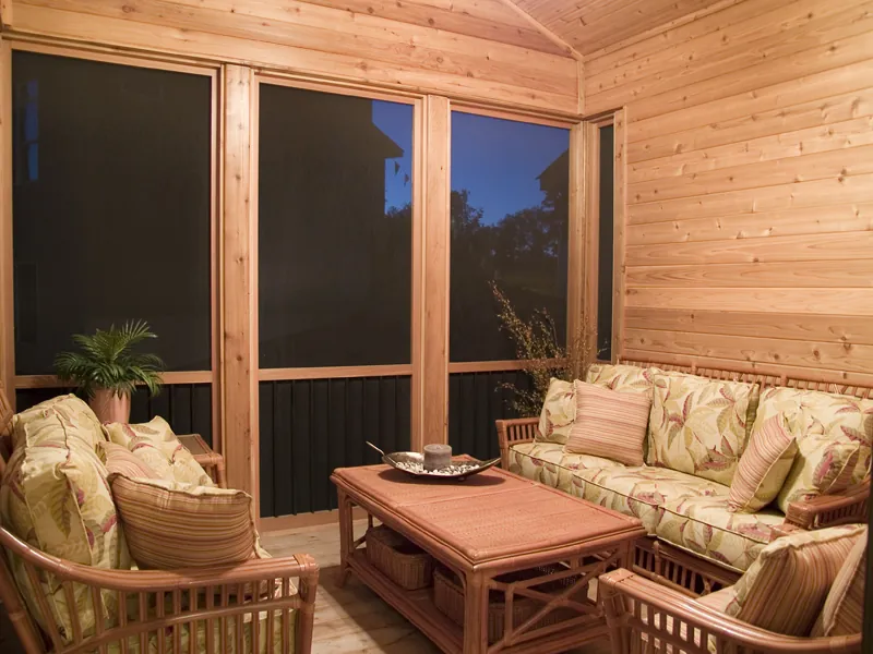 Screen porch is rustic yet spacious enough for outdoor enjoyment.