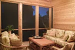 Screen porch is rustic yet spacious enough for outdoor enjoyment.
