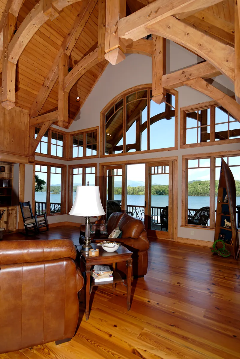 082S-0001 Great room with two-story ceiling and rustic beams.